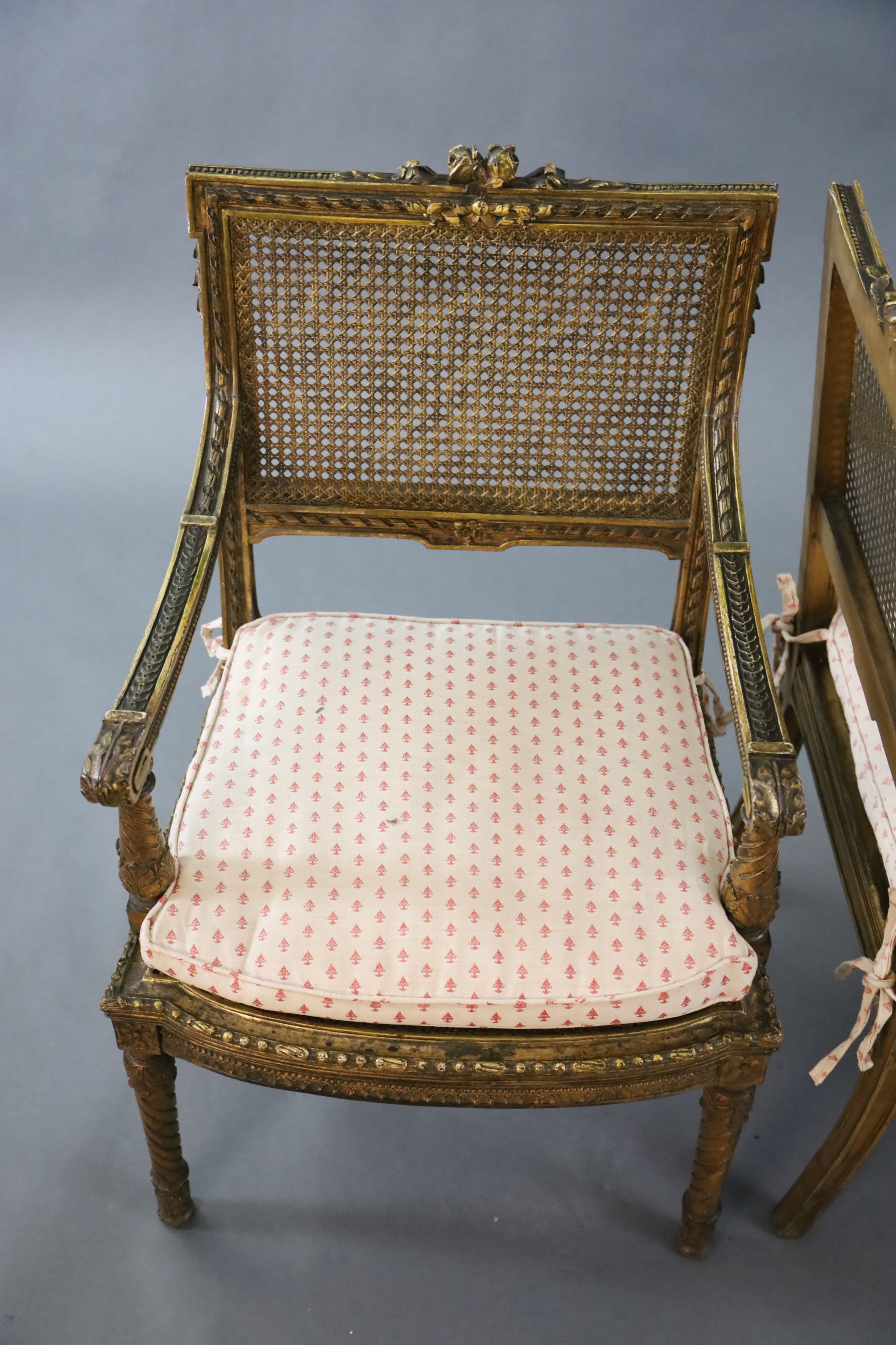 A pair of Louis XVI style walnut giltwood fauteuils, W.1ft 10in. D.1ft 9in. H.3ft 1in.